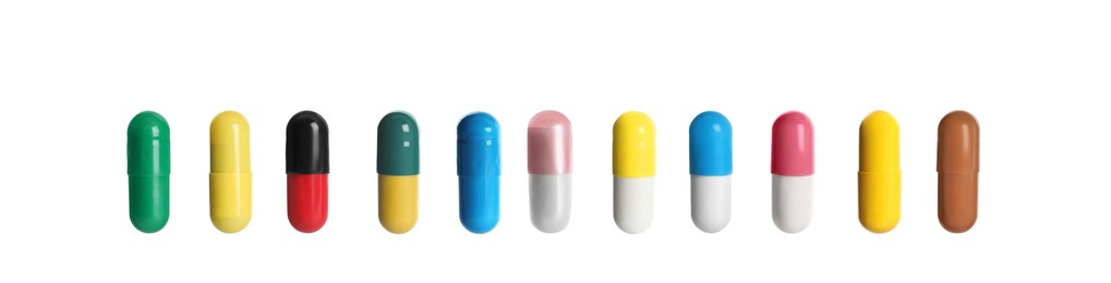 Image of Set of different color pills in row isolated on white