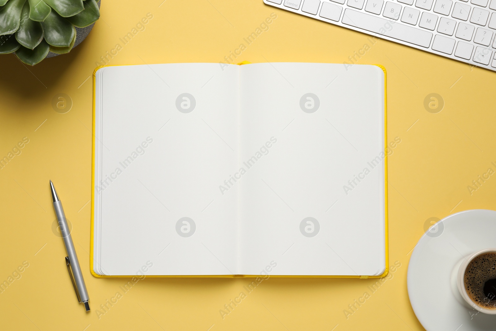 Photo of Flat lay composition with stylish notebook on yellow background