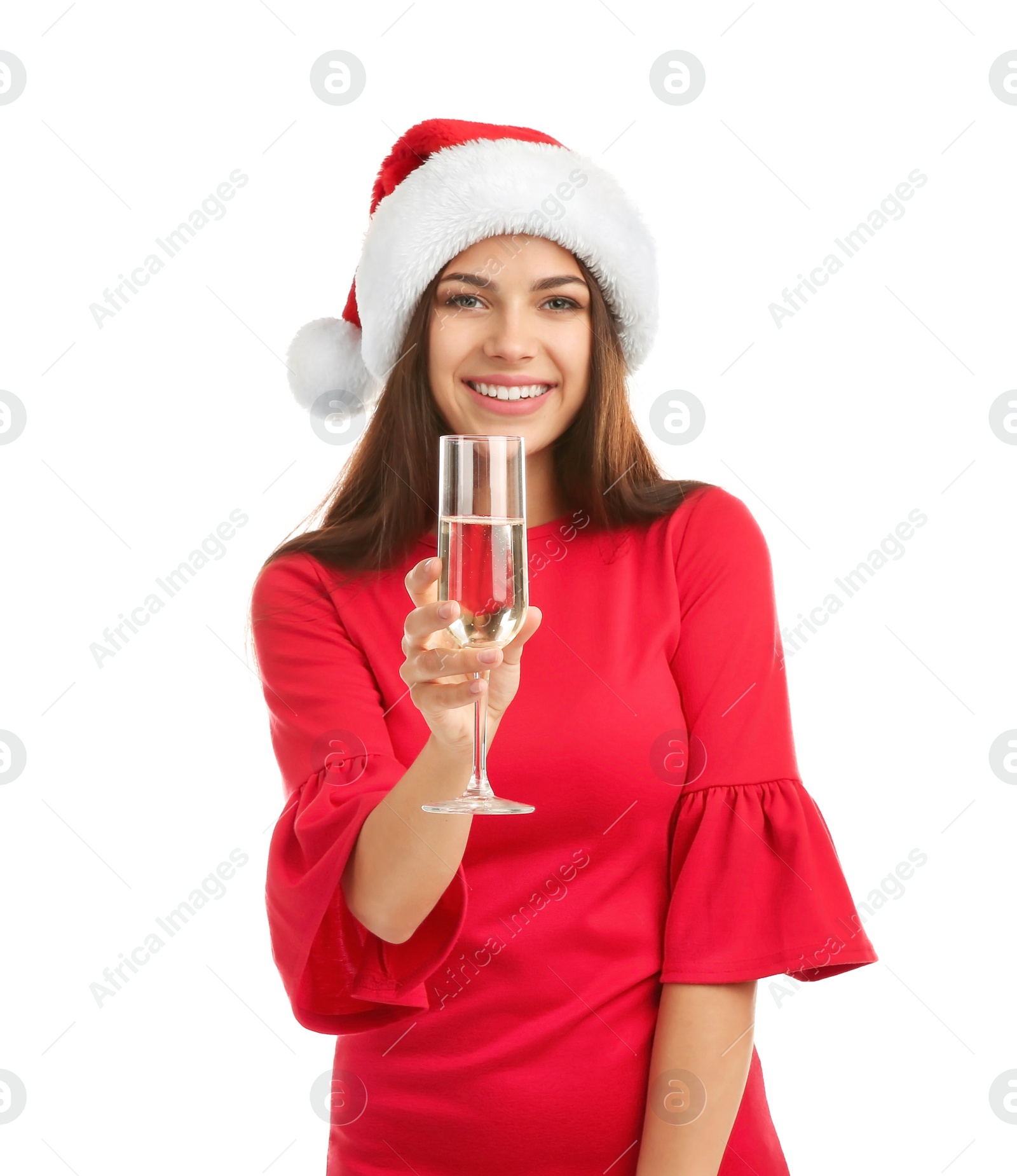 Photo of Young beautiful woman in Santa hat holding glass of champagne on white background. Christmas celebration