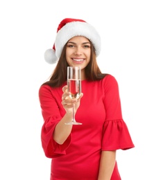 Photo of Young beautiful woman in Santa hat holding glass of champagne on white background. Christmas celebration