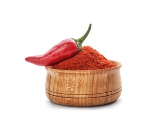 Photo of Bowl of chili pepper powder and fresh vegetable on white background