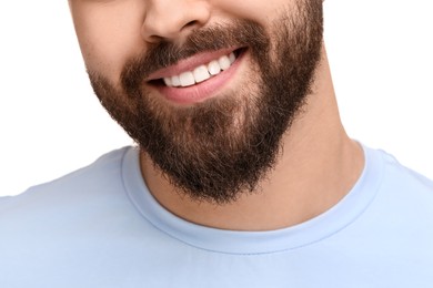 Man with clean teeth smiling on white background, closeup