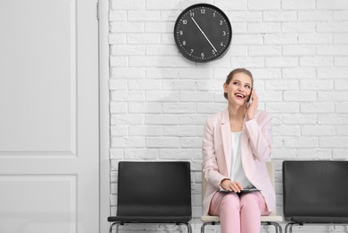 Young woman waiting for job interview, indoors