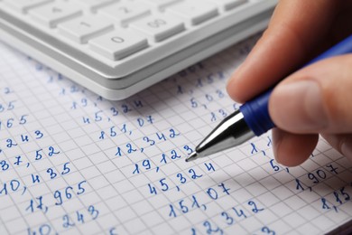 Photo of Woman working with data using calculator, closeup