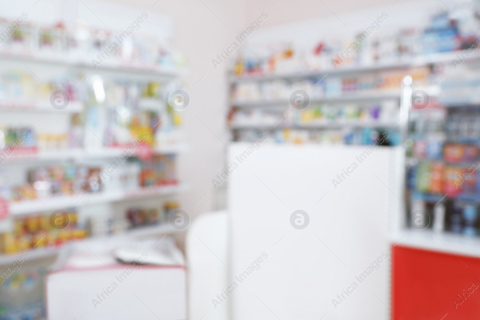 Photo of Blurred view of shelves with pharmaceuticals in modern drugstore