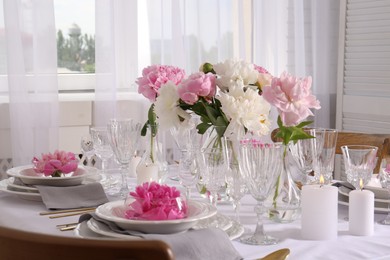 Stylish table setting with beautiful peonies in dining room