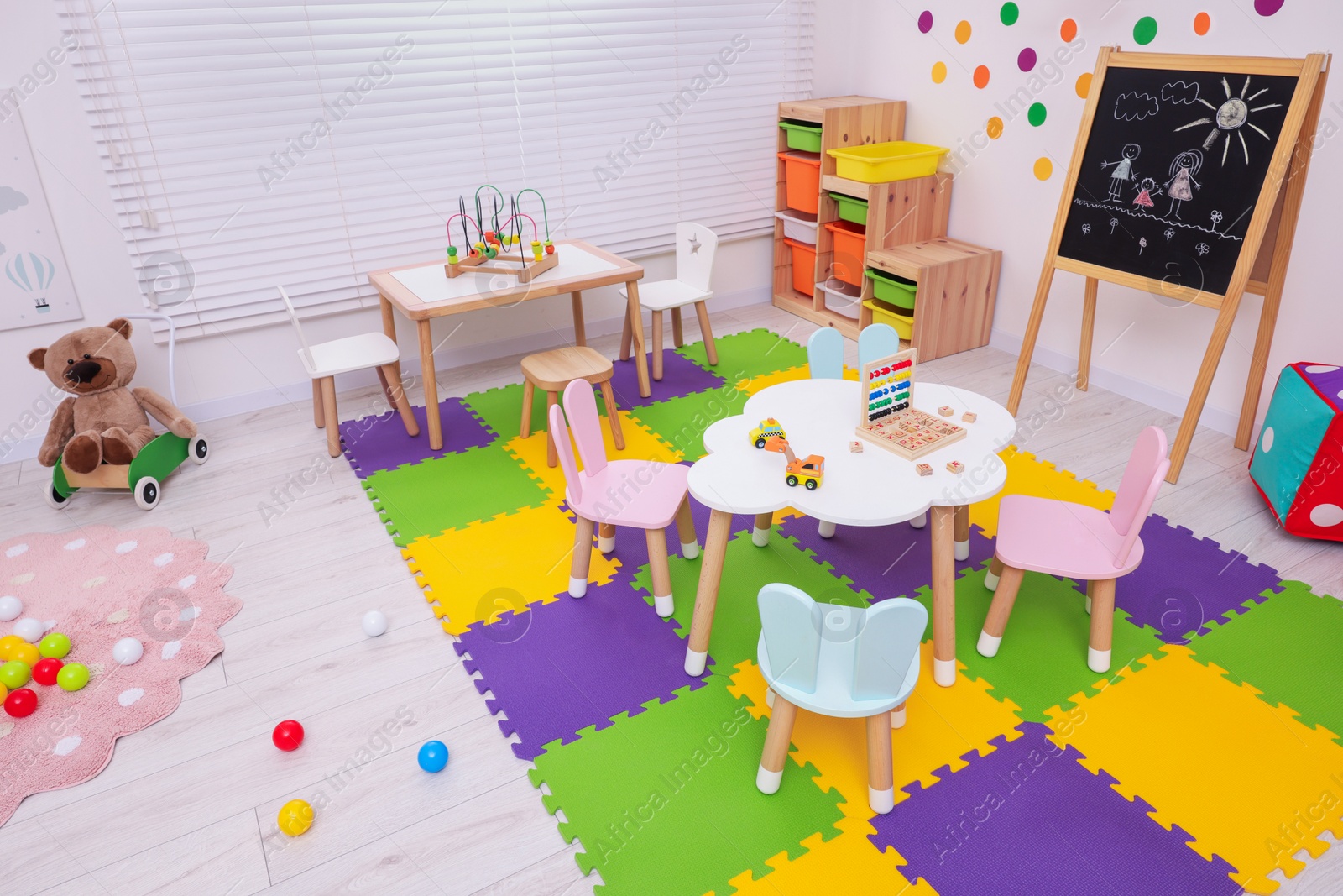 Photo of Stylish kindergarten interior with toys and modern furniture