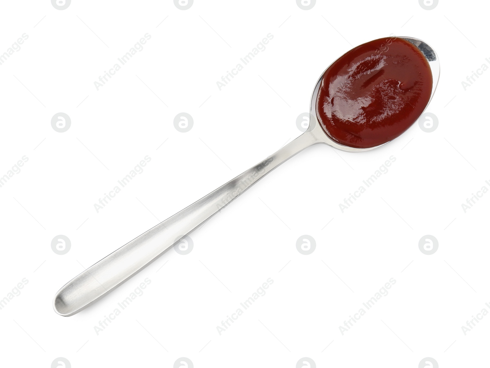 Photo of Tasty barbecue sauce in spoon isolated on white, top view