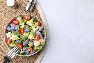 Delicious salad with cauliflower and tomato served on white table, flat lay. Space for text