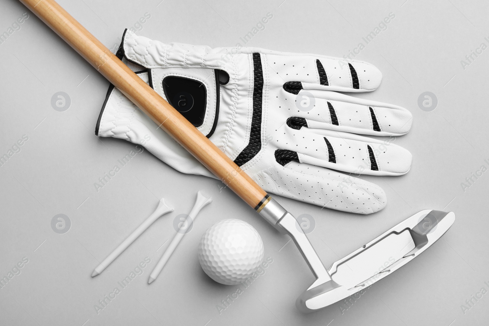 Photo of Set of golf equipment on grey background, flat lay