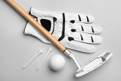 Photo of Set of golf equipment on grey background, flat lay