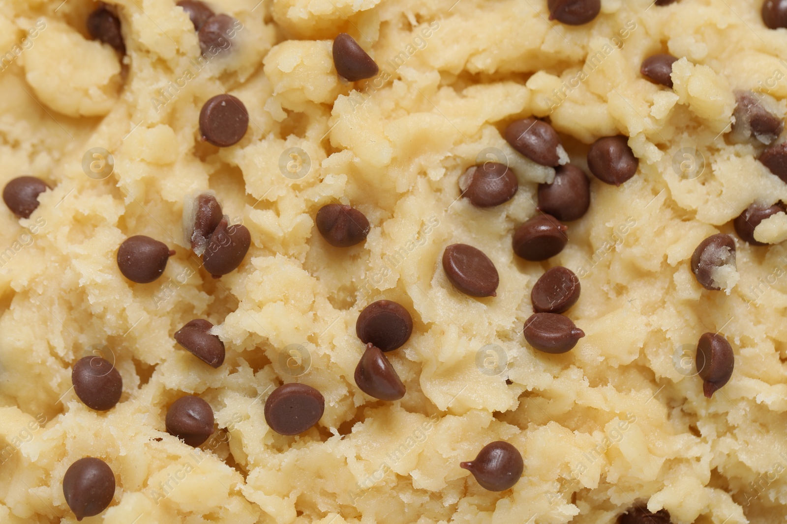 Photo of Raw dough for chocolate chip cookies as background, top view