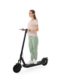 Happy woman riding modern electric kick scooter on white background