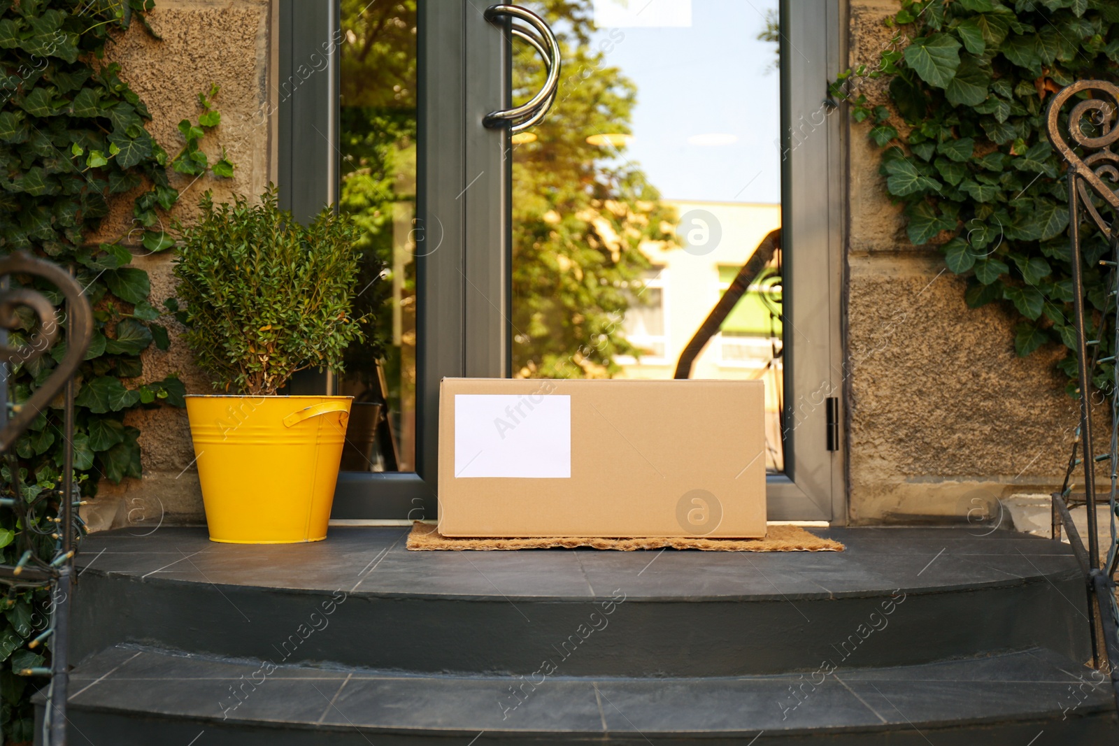 Photo of Delivered parcel on door mat near entrance