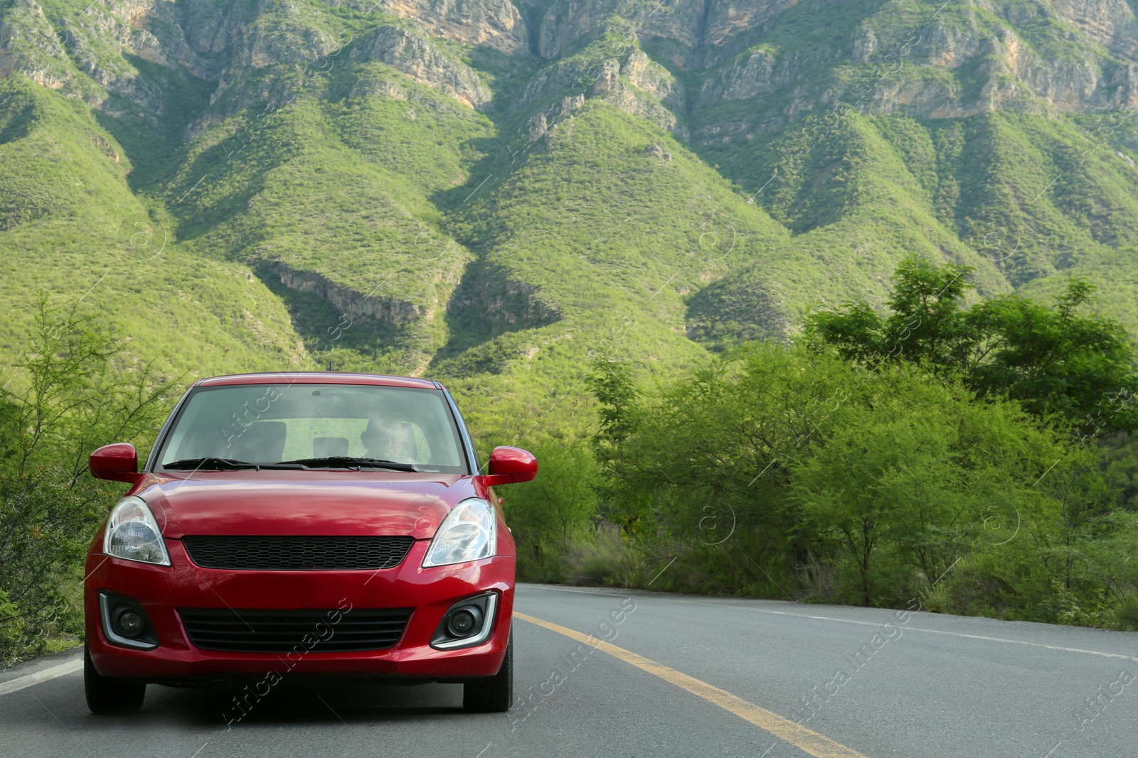 Photo of Beautiful view of car on asphalt highway in mountains. Road trip