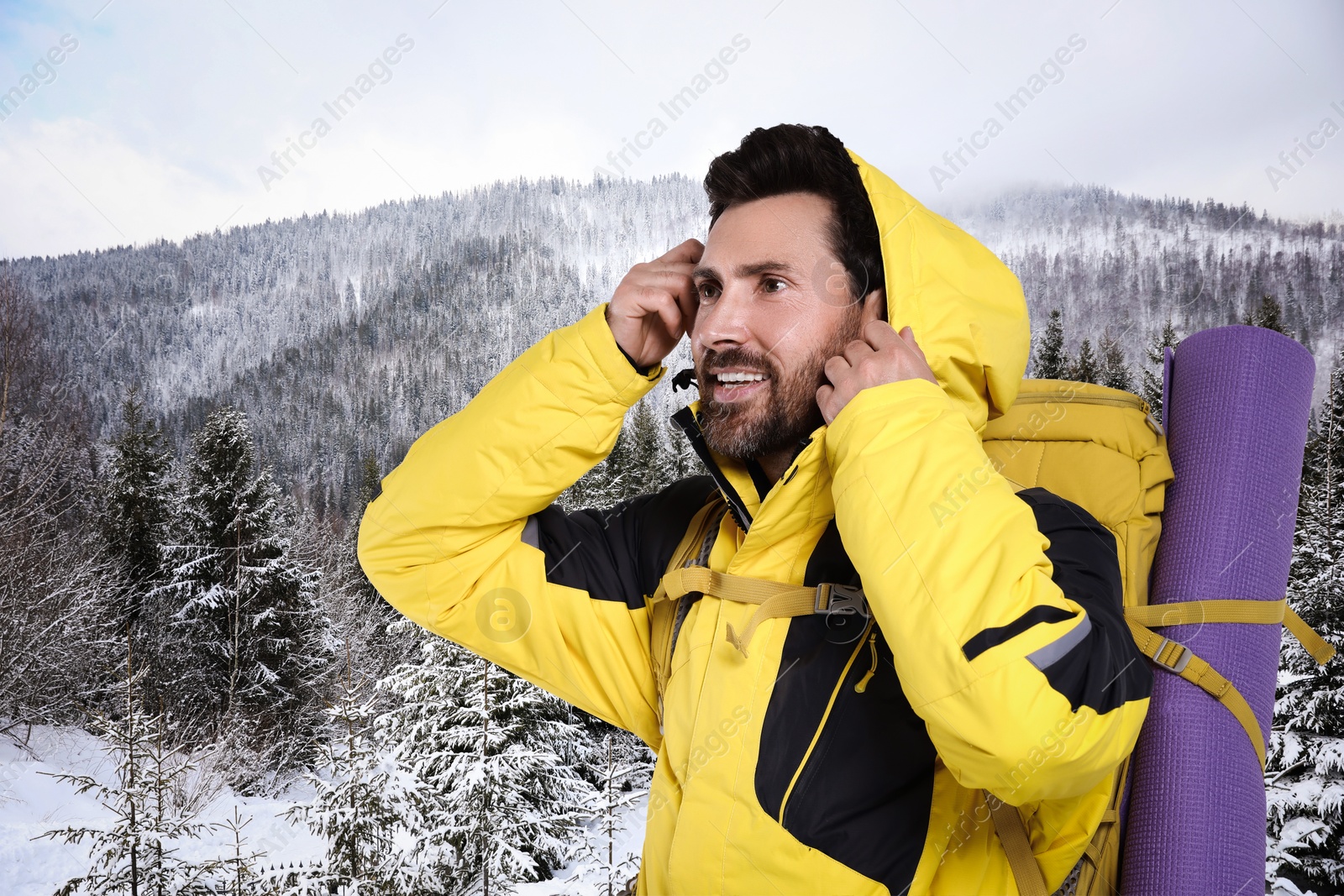 Image of Happy tourist with backpack in snowy mountains