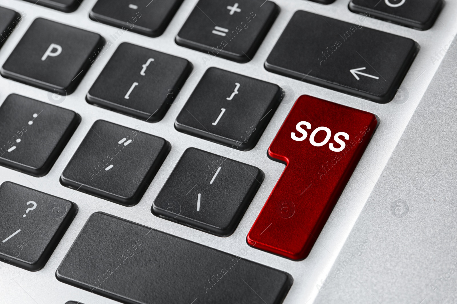 Image of Red button with word SOS on computer keyboard, closeup. Rescue concept