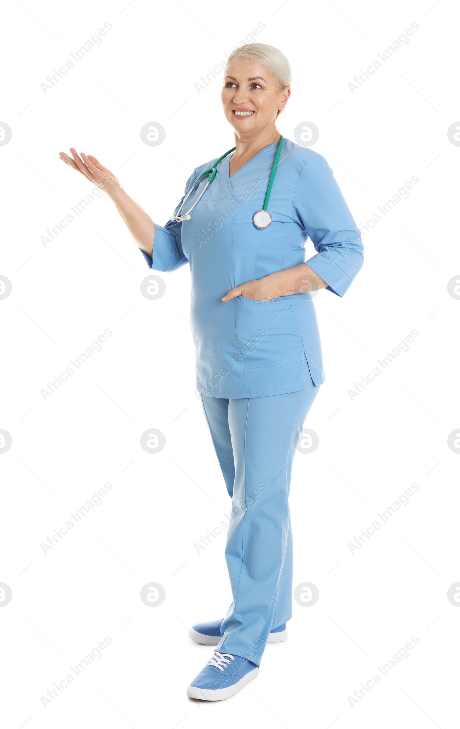 Photo of Full length portrait of female doctor in scrubs isolated on white. Medical staff