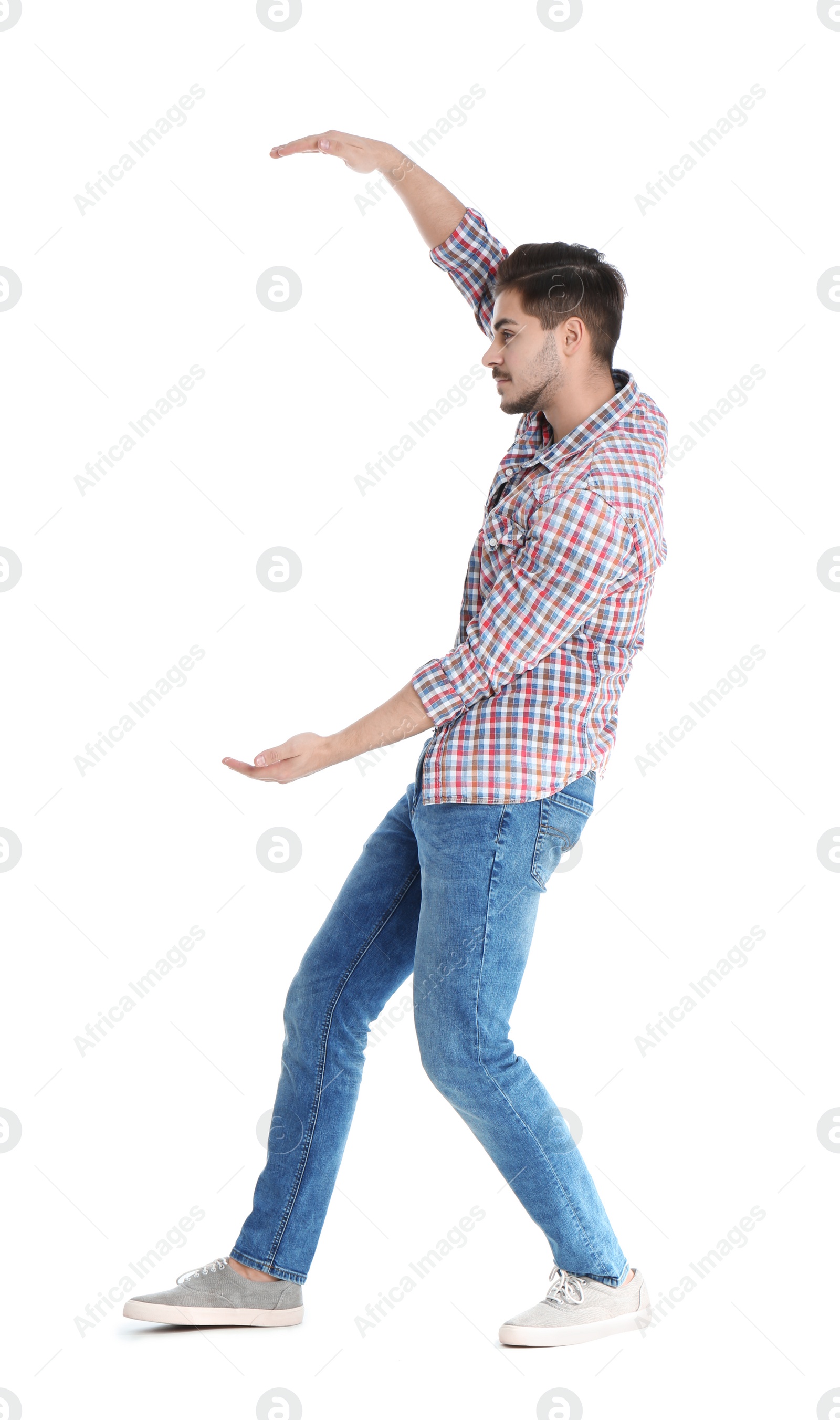 Photo of Young man with magnet attracting people on white background