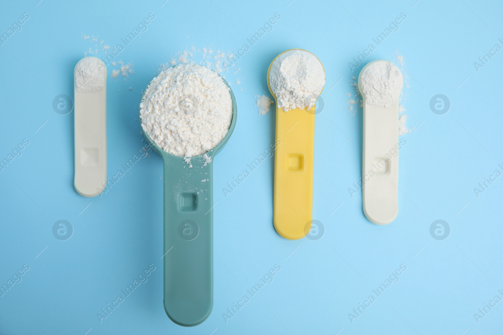 Photo of Amino acid powder on light blue background, flat lay