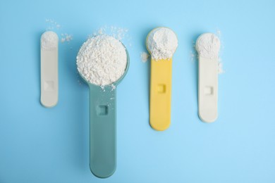 Amino acid powder on light blue background, flat lay