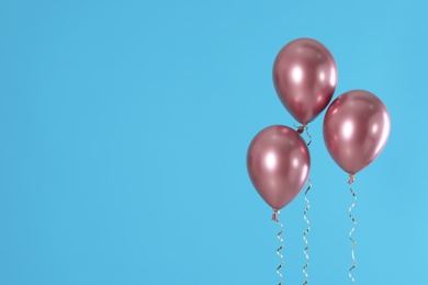 Photo of Bright balloons on color background. Space for text