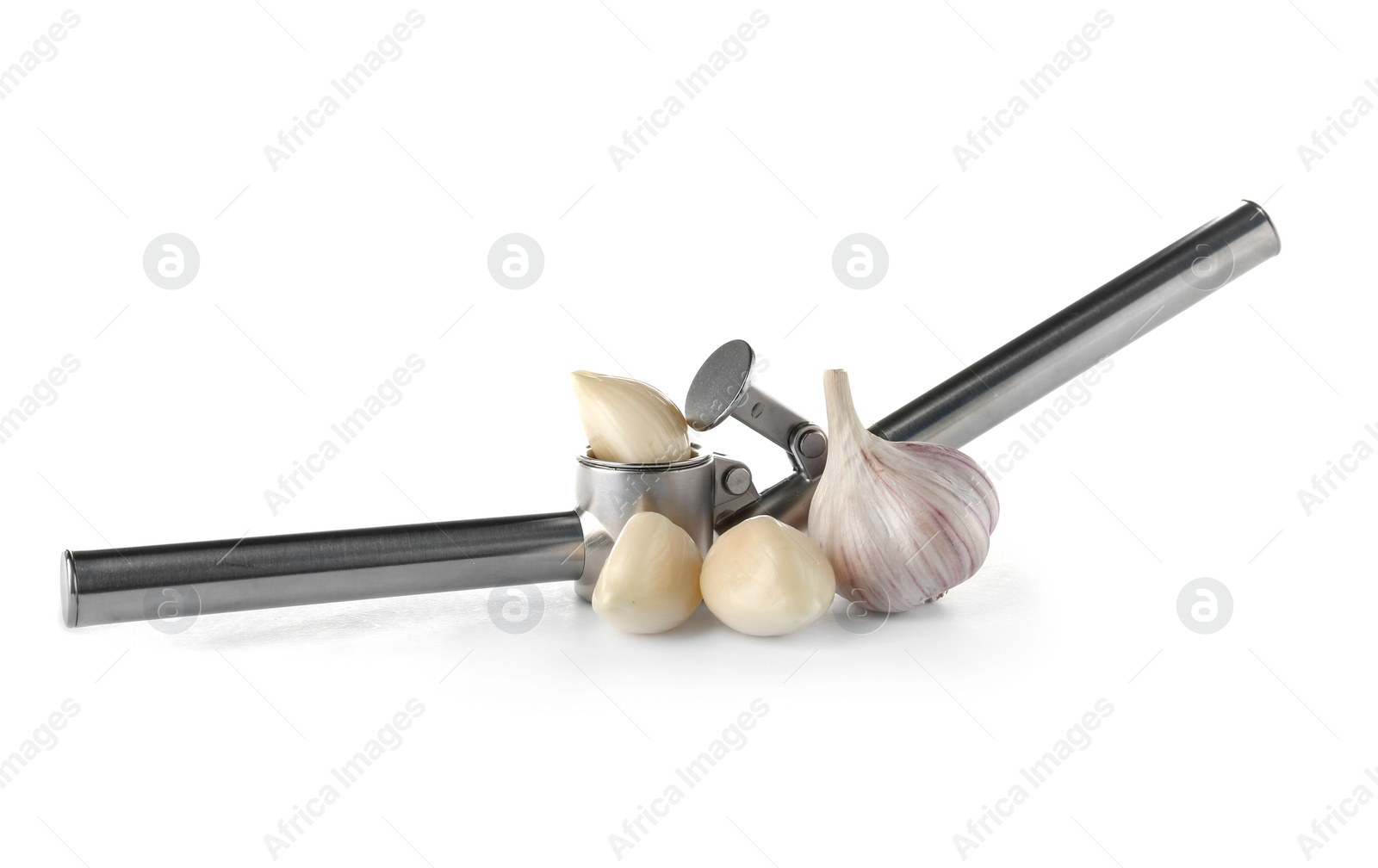 Photo of Garlic press and cloves on white background. Kitchen utensil