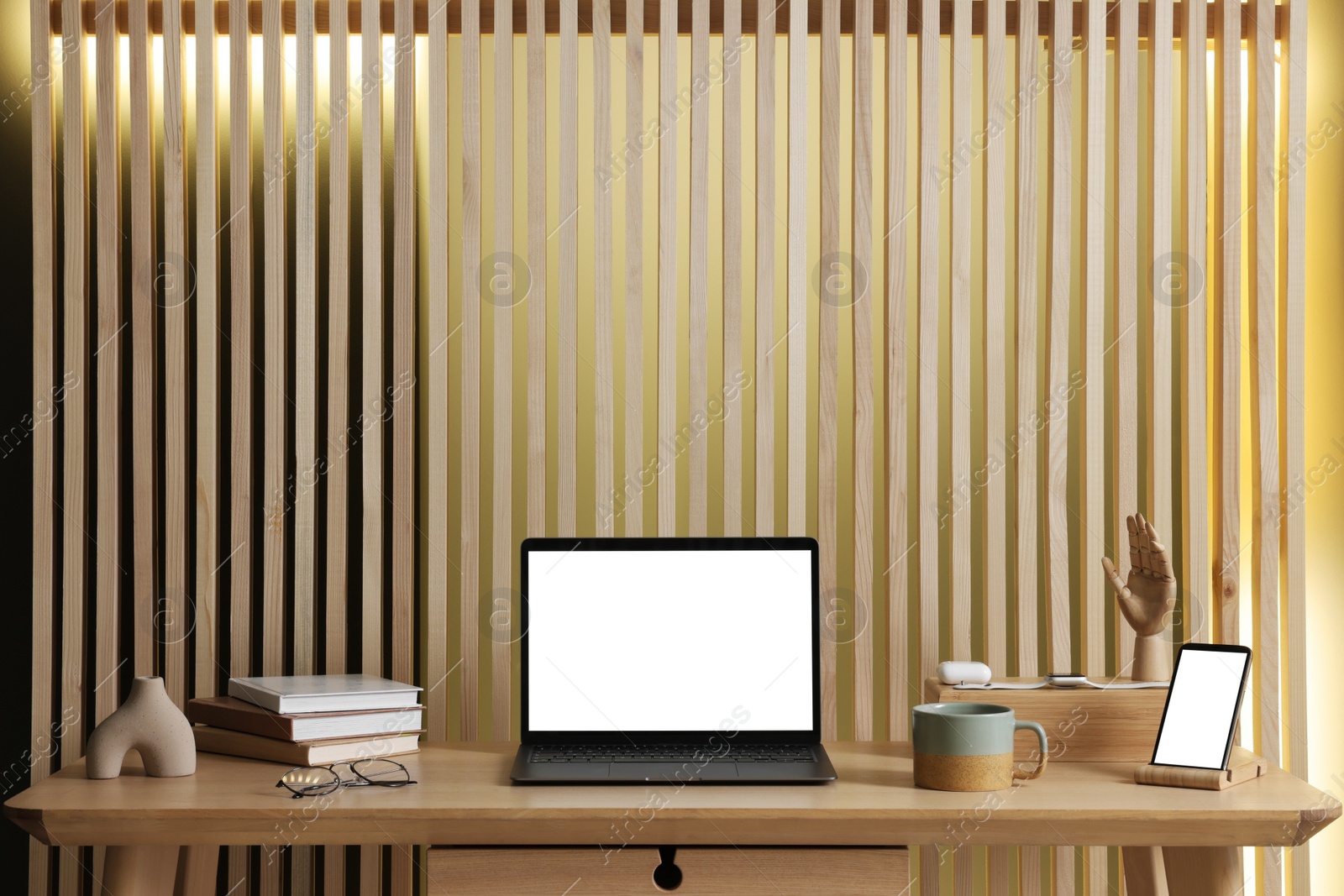 Photo of Stylish workplace with laptop and stationery on wooden table indoors