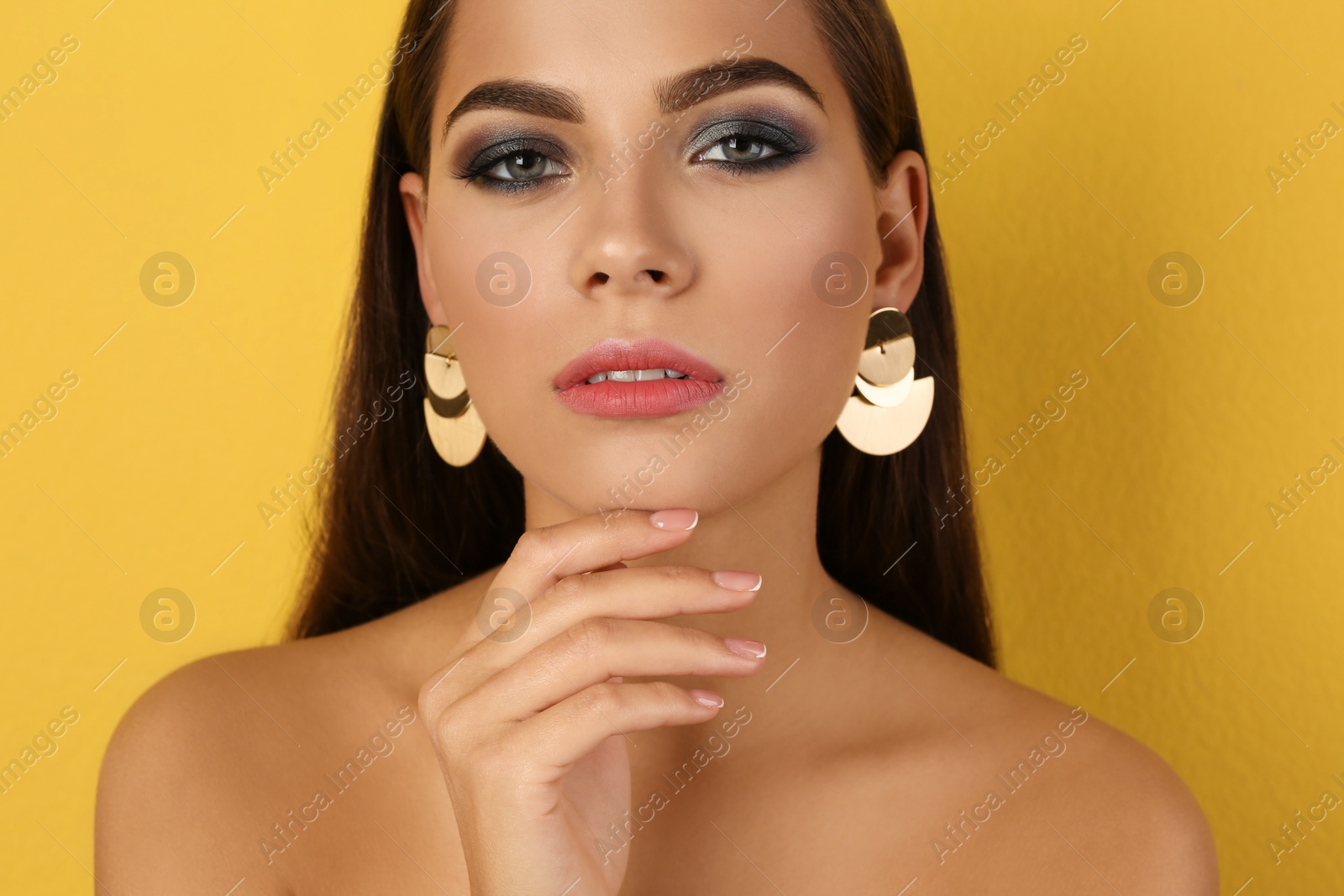 Photo of Portrait of beautiful woman with stylish makeup on color background