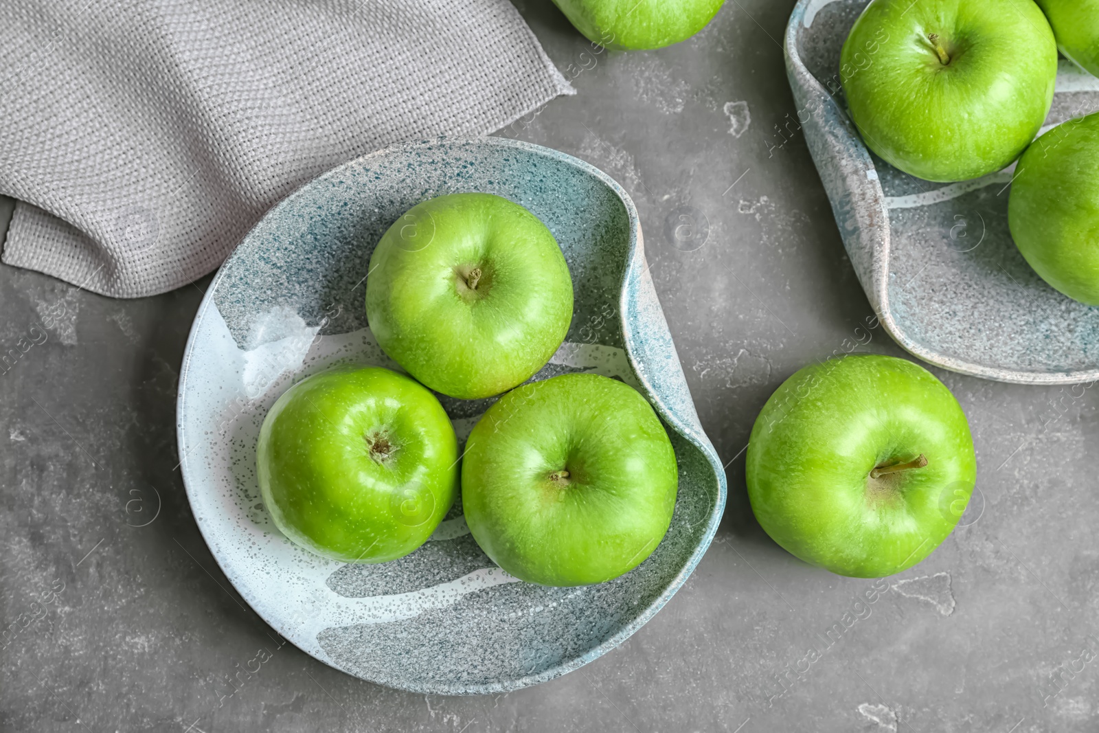 Photo of Composition with fresh green apples on grey table, top view