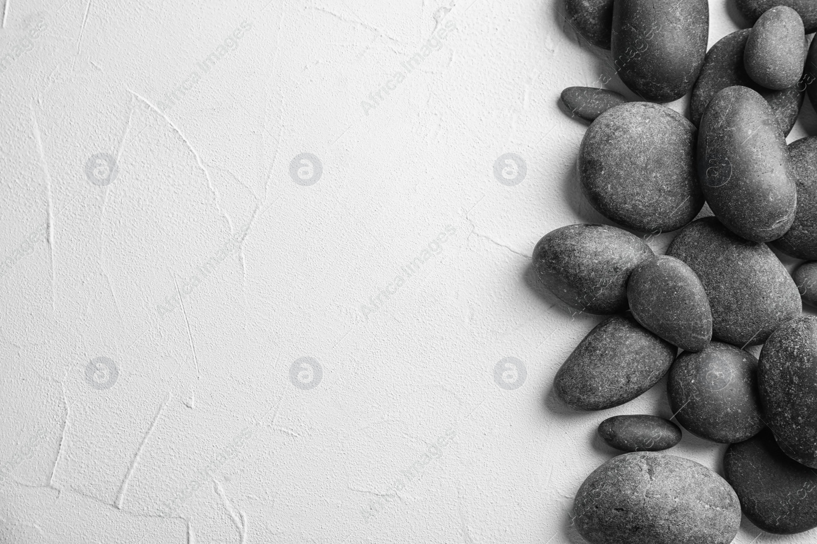 Photo of Zen stones on light background, top view with space for text