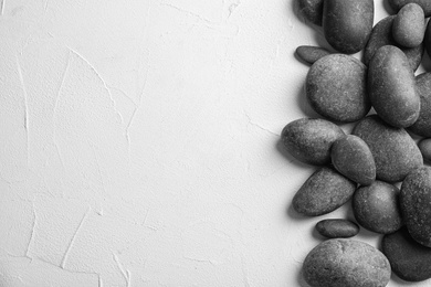 Photo of Zen stones on light background, top view with space for text