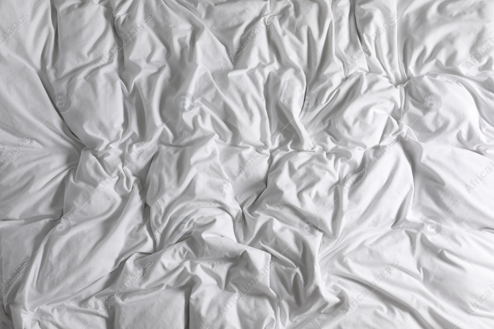 Photo of Crumpled white fabric as background, closeup view