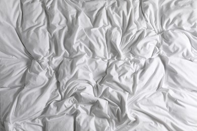 Photo of Crumpled white fabric as background, closeup view