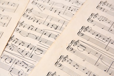 Photo of Sheets of paper with different notes as background, closeup