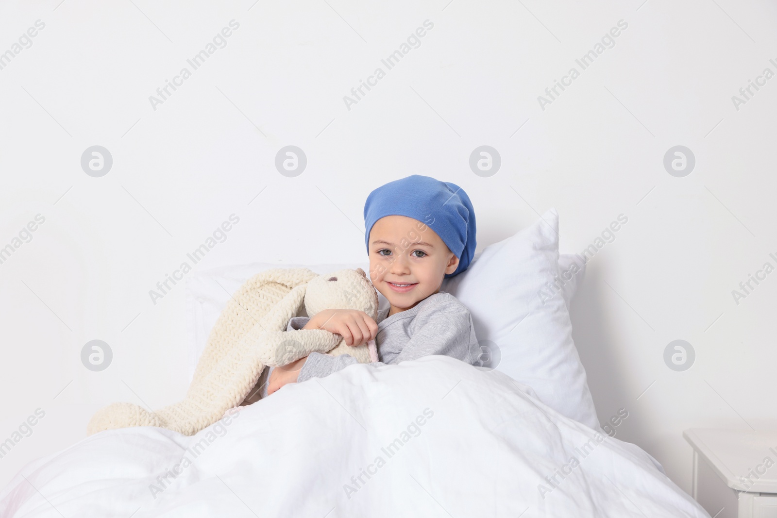 Photo of Childhood cancer. Girl with toy bunny in hospital