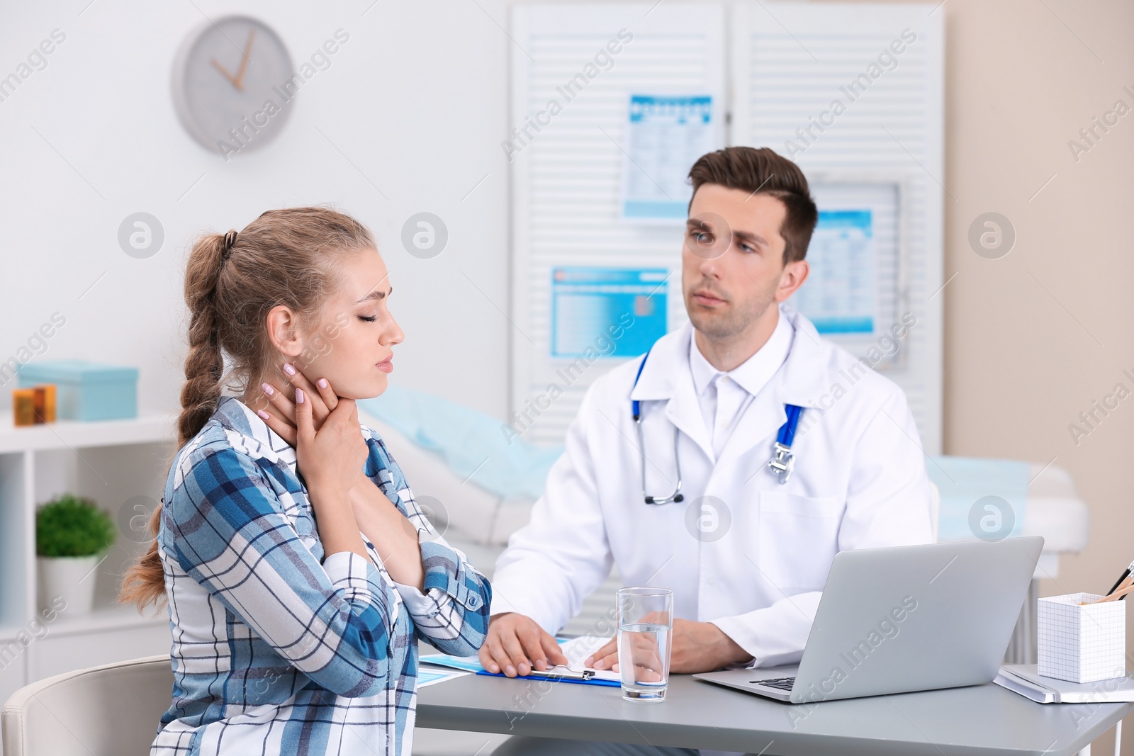 Photo of Coughing young woman visiting doctor at clinic