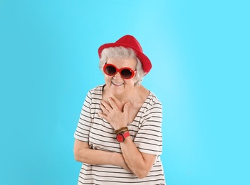 Portrait of cool grandmother on color background