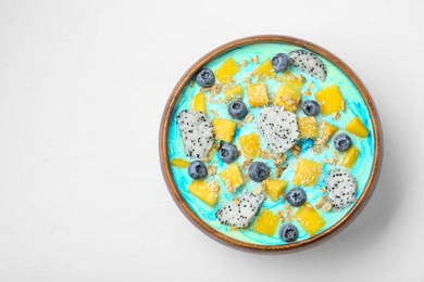 Delicious smoothie bowl with fresh fruits, blueberries and oatmeal on white background, top view. Space for text