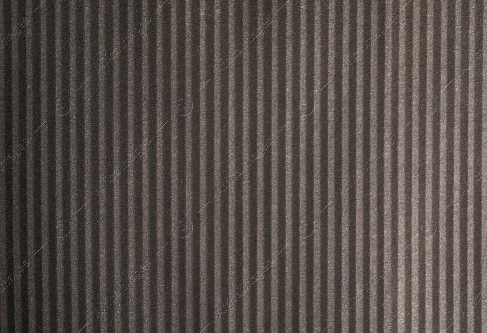 Photo of Dark grey corrugated sheet of cardboard as background, top view