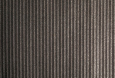 Photo of Dark grey corrugated sheet of cardboard as background, top view