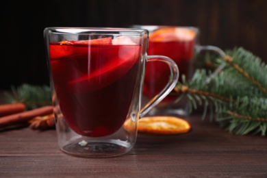 Delicious hot mulled wine on wooden table