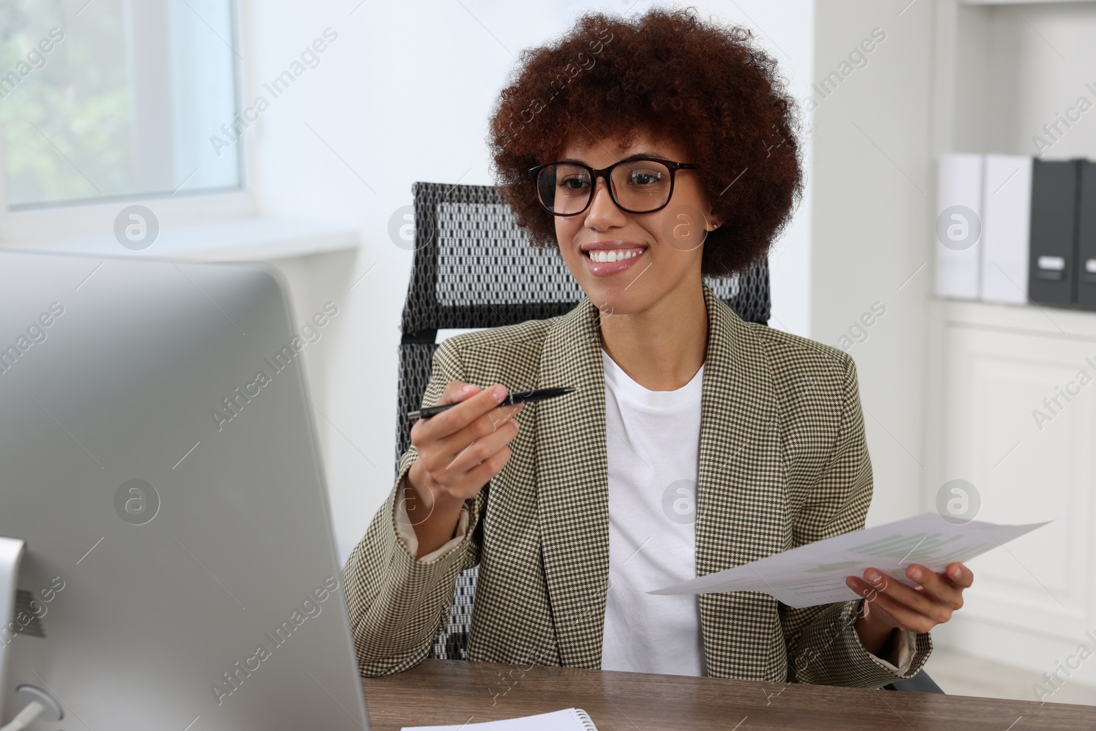 Photo of Professional accountant having video chat via computer at desk in office