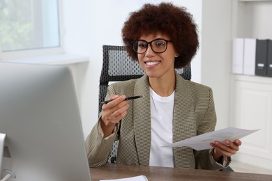 Photo of Professional accountant having video chat via computer at desk in office