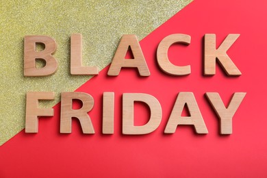 Photo of Words Black Friday made of wooden letters on color background, flat lay