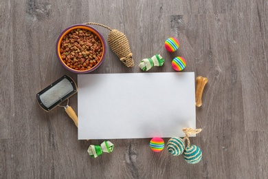 Photo of Flat lay composition with cat accessories and food on wooden background