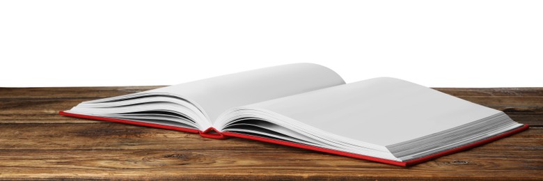 Photo of Open book with red cover on wooden table against white background