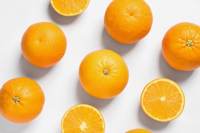 Composition with ripe oranges on white background, top view