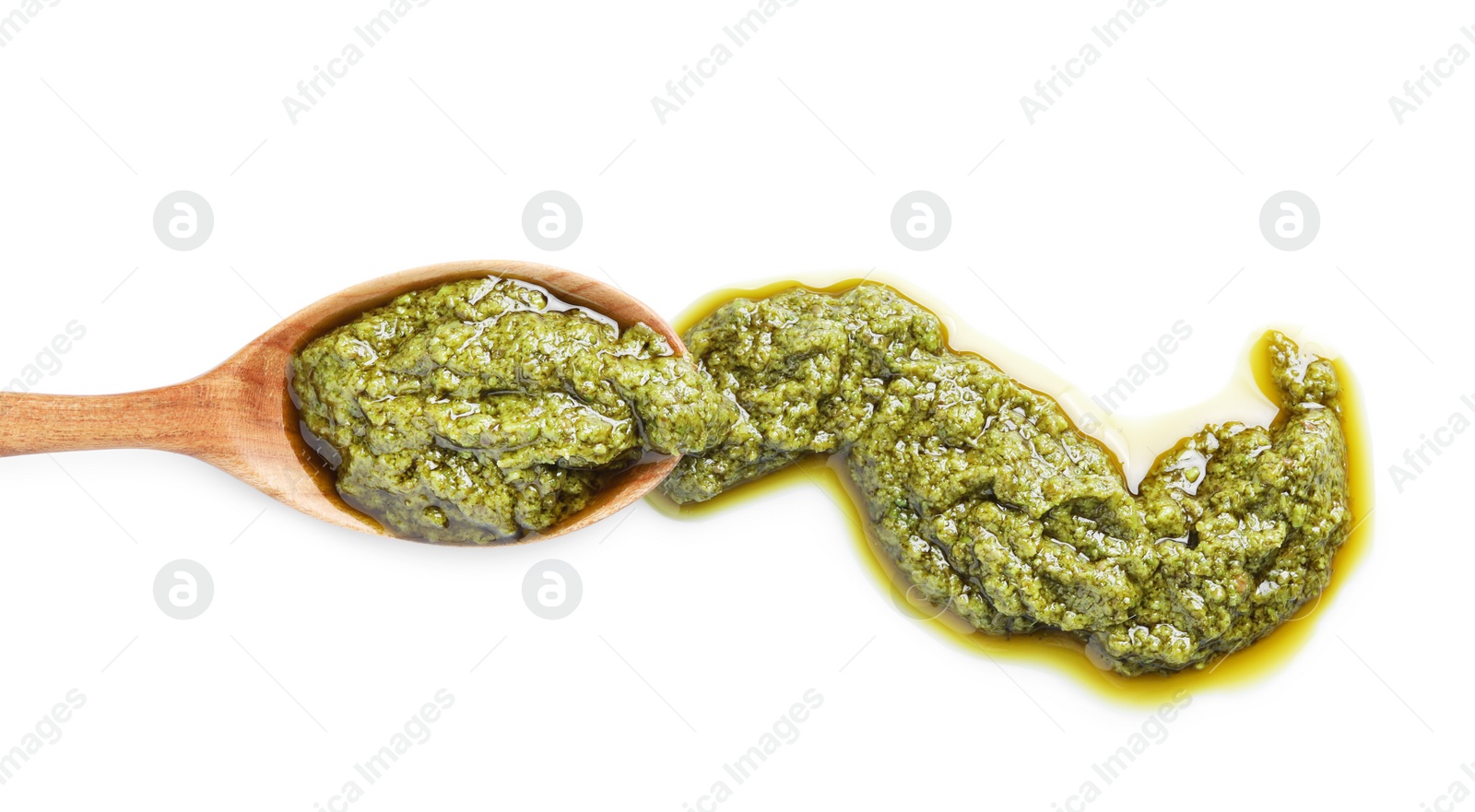 Photo of Sample of tasty pesto sauce and spoon isolated on white, top view