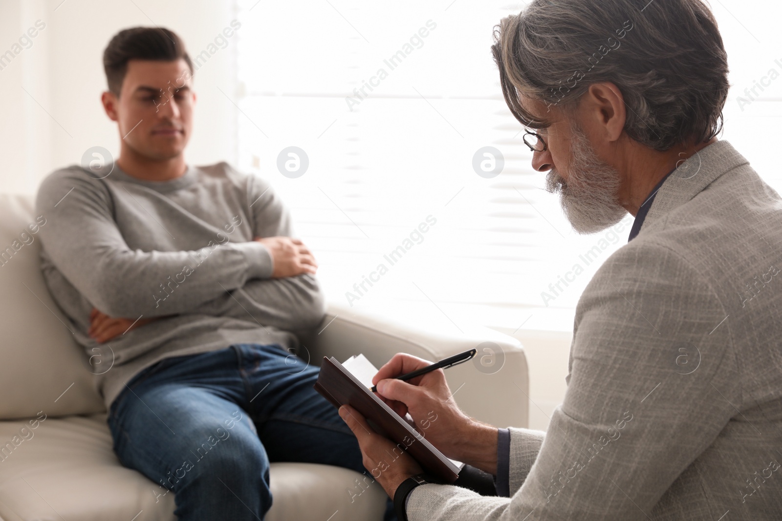 Photo of Psychotherapist and patient in office. Hypnotherapy session